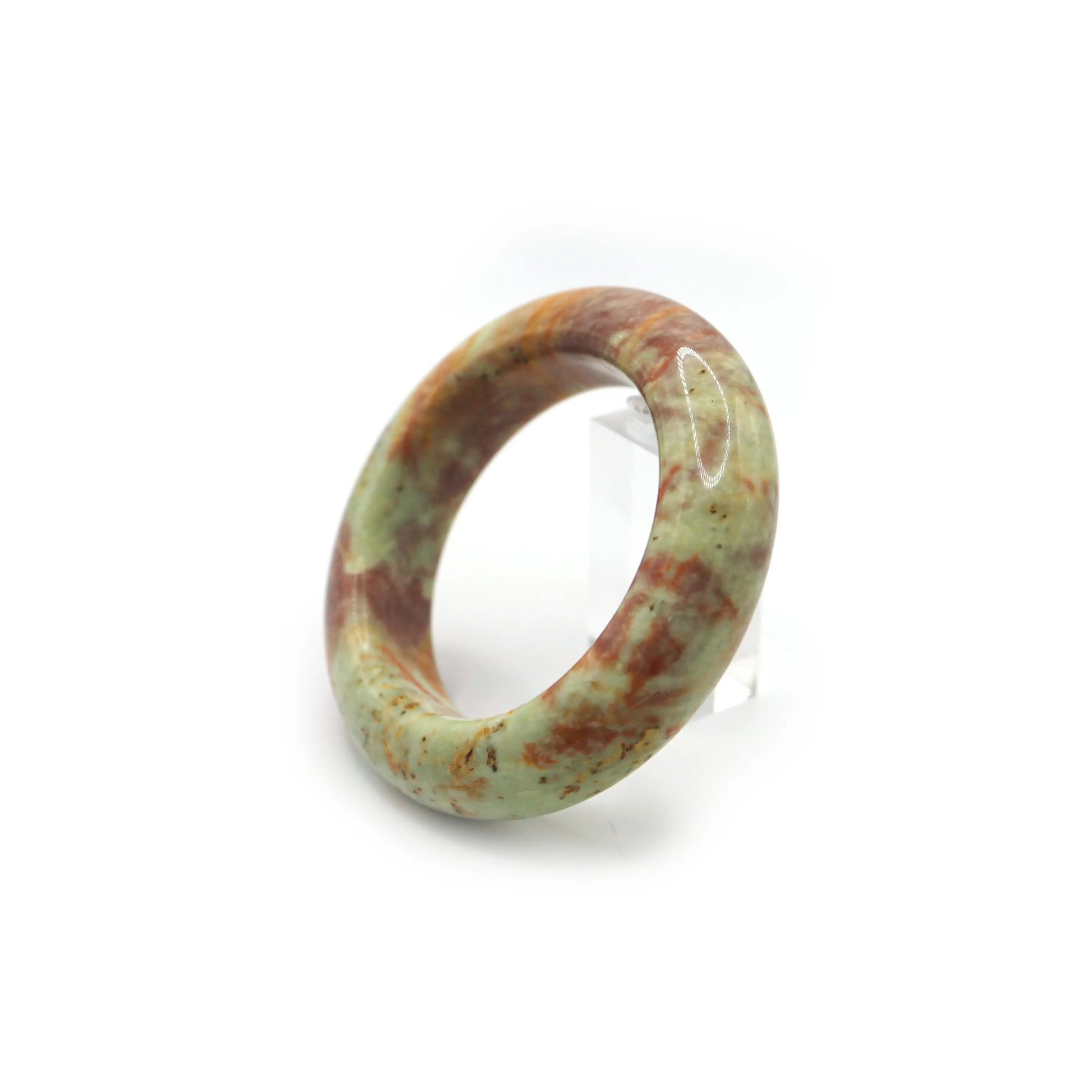 Close-up of natural jade bracelet showing marbled mineral color layers - Miruzi
