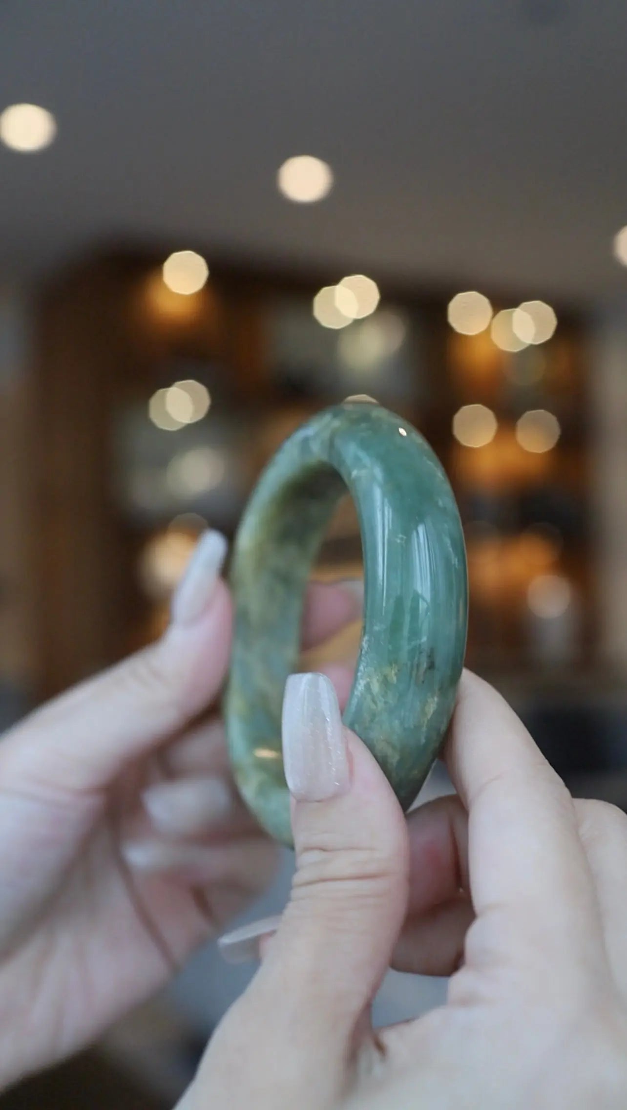 Minimalist jade bracelet made from untreated Mongolian serpentine, glowing with earthy yellow and green hues, perfect for nature-inspired styling – Miruzi