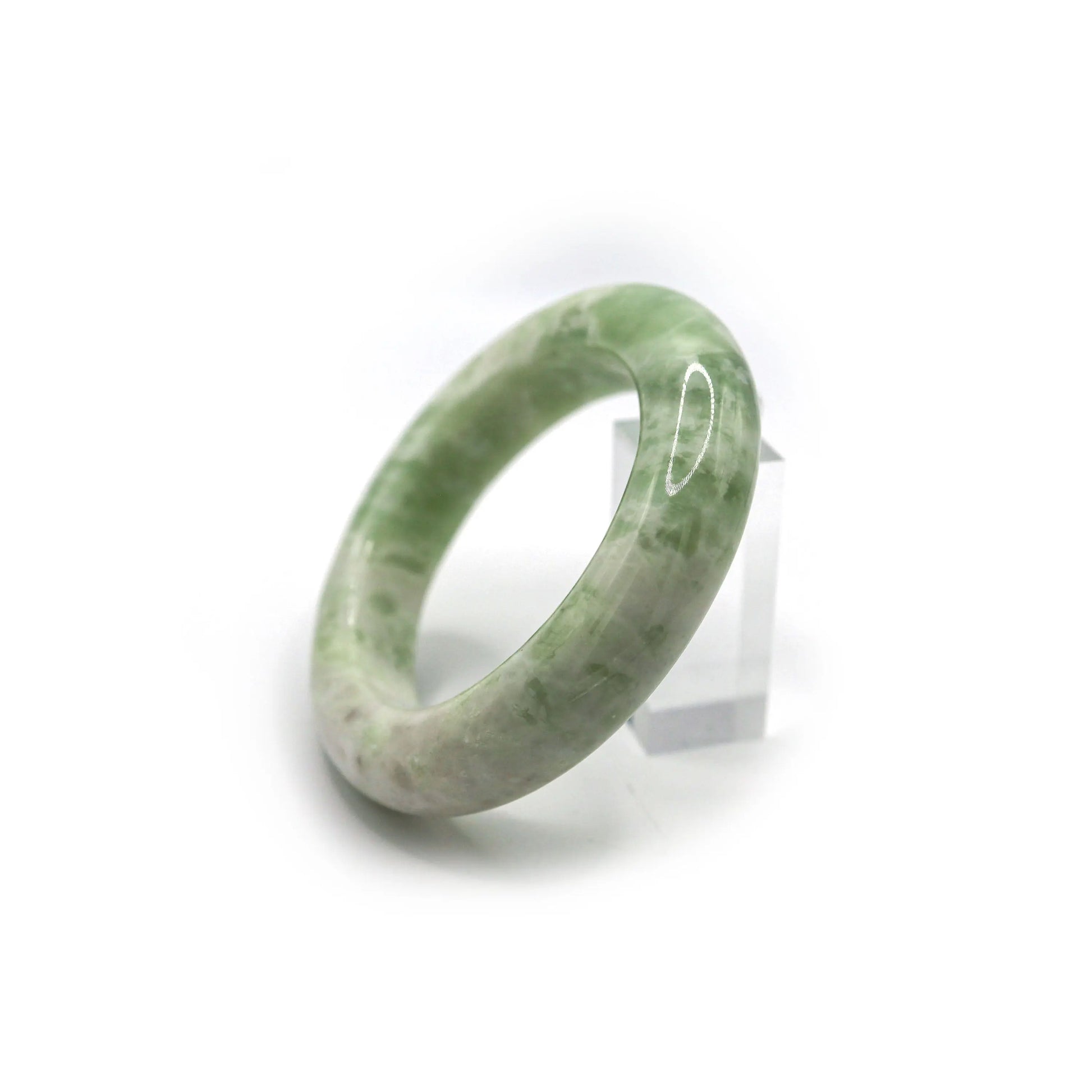 Serpentine jade bracelet glowing in daylight with smooth marbled texture Miruzi