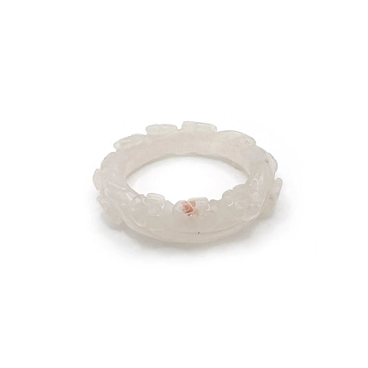 Artisan hand-carved lotus flower bracelet crafted from blush pink Mongolian jade, showcasing delicate lotus motifs and expert craftsmanship in every detail.