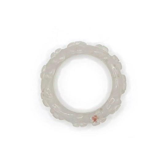 Artisan hand-carved lotus flower bracelet crafted from blush pink Mongolian jade, showcasing delicate lotus motifs and expert craftsmanship in every detail.