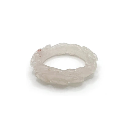 Artisan hand-carved lotus flower bracelet crafted from blush pink Mongolian jade, showcasing delicate lotus motifs and expert craftsmanship in every detail.