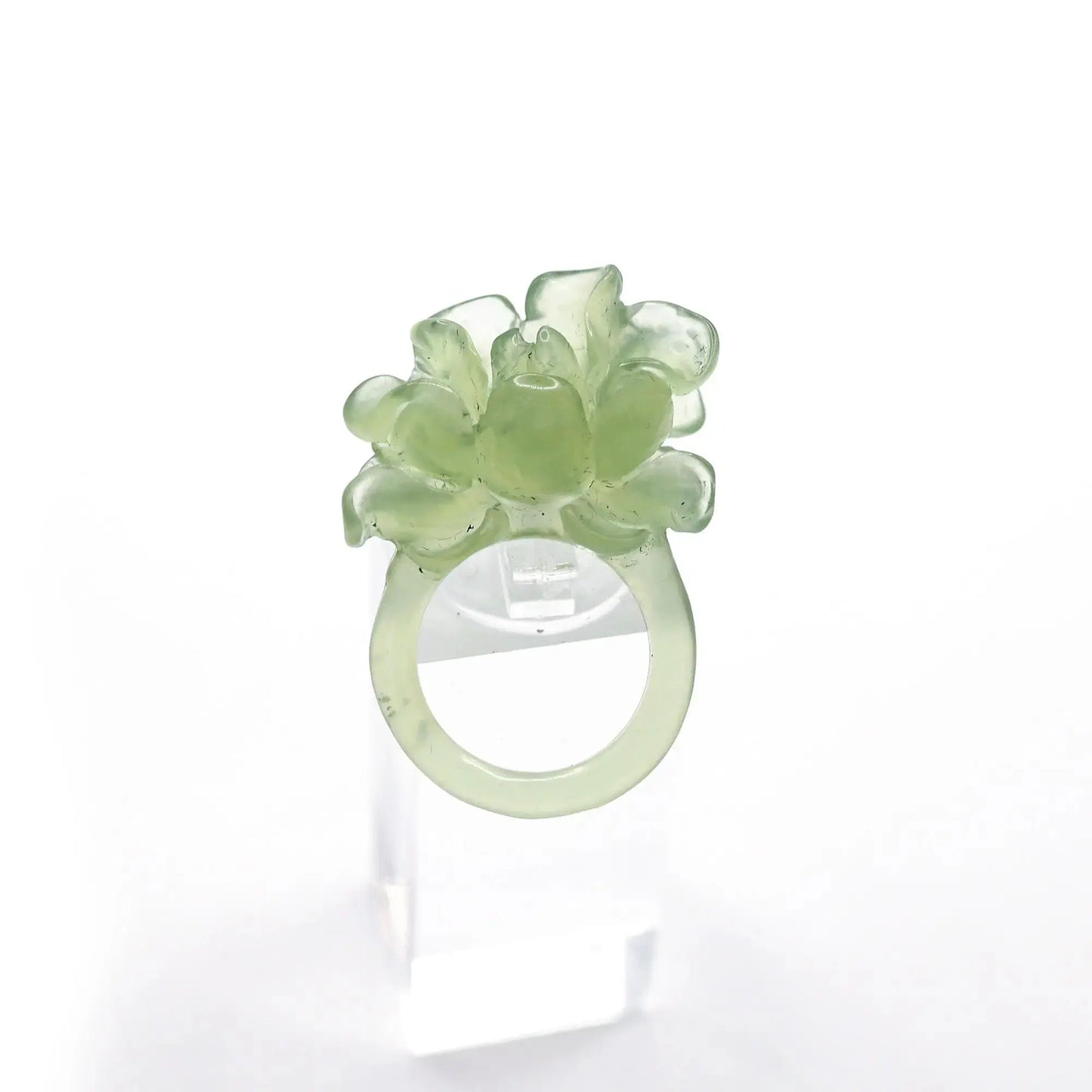 Lotus flower ring hand-carved from serpentine, featuring a soft green lotus bloom atop a clear base—symbolizing purity, peace, and artistic elegance.
