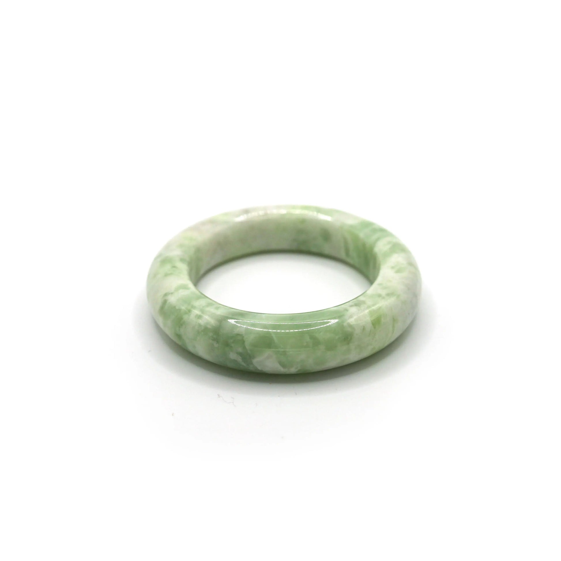 Matcha green jade bracelet with creamy white marbling on soft neutral fabric -Miruzi