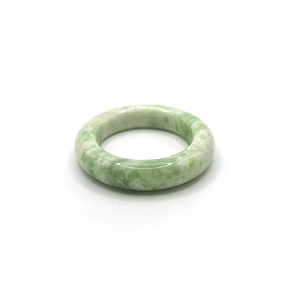 Matcha green jade bracelet with creamy white marbling on soft neutral fabric -Miruzi