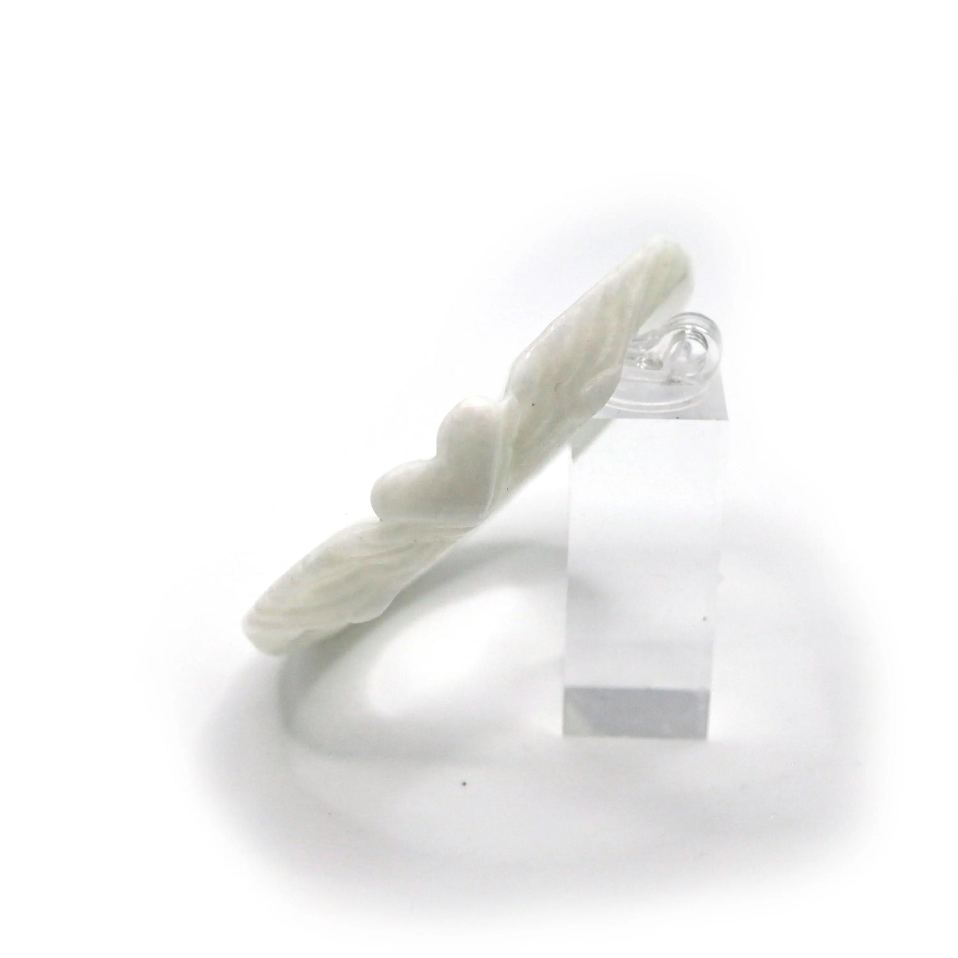 Elegant white jade bracelet with subtle heart and feather patterns engraved along its surface, styled for a soft, poetic look – Miruzi