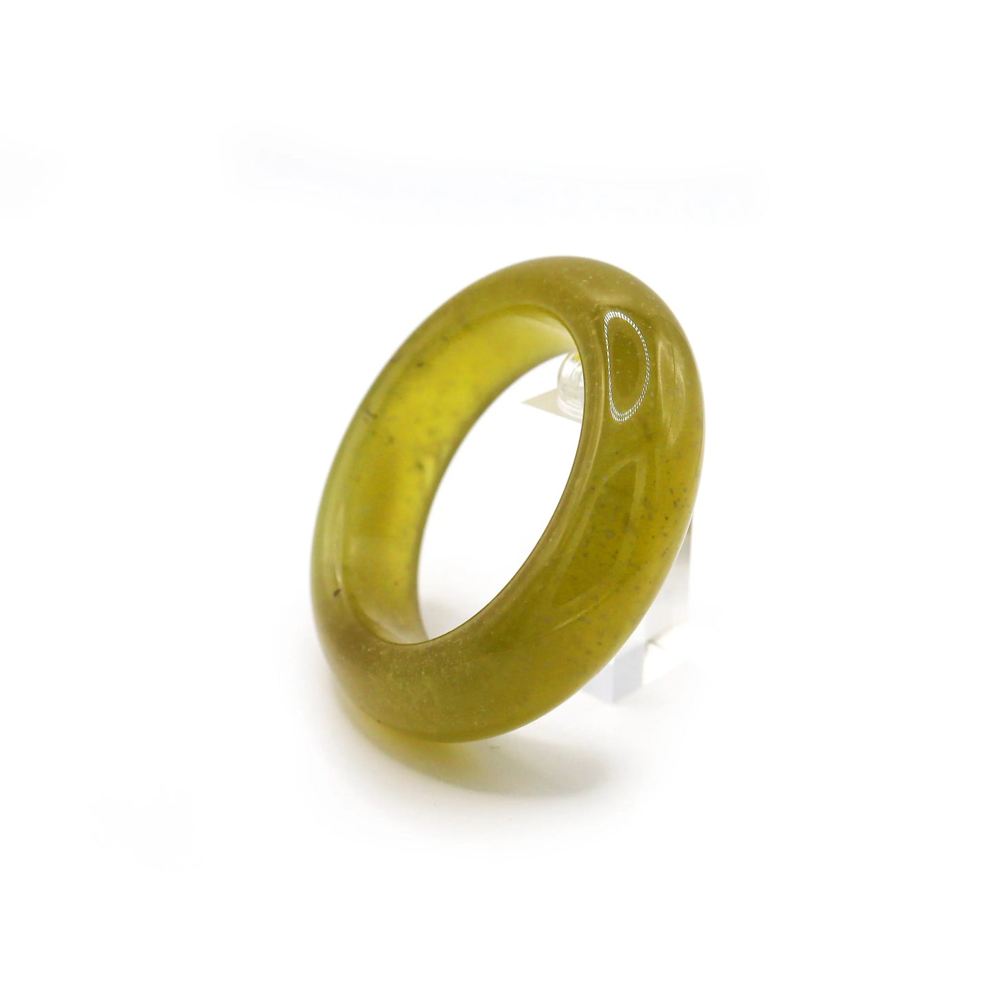 Slim, fully transparent yellow jade bracelet with natural effervescent patterns, styled with white and gold tones. Miruzi
