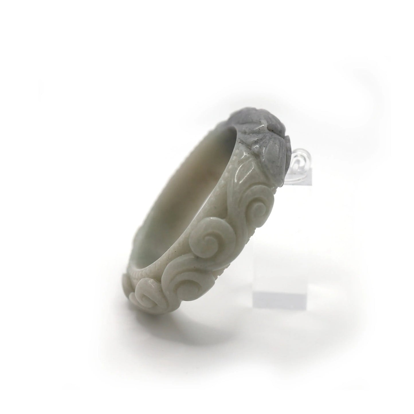 Pale green jade bangle with black sesame-colored peony carving surrounded by cloud forms and etched ring textures for balance – Miruzi