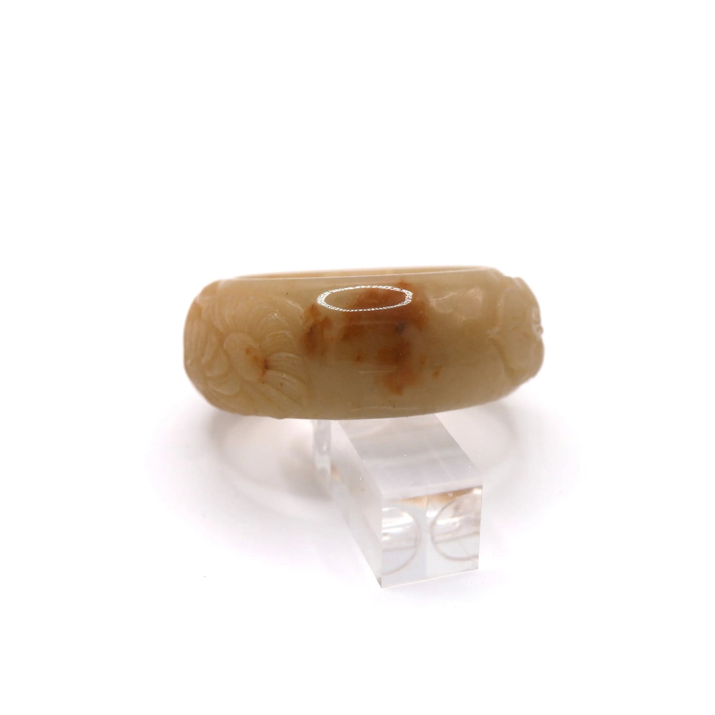 Traditional botanical symbols carved in relief onto a smooth yellow jade bracelet, blending craftsmanship and natural artistry – Miruzi