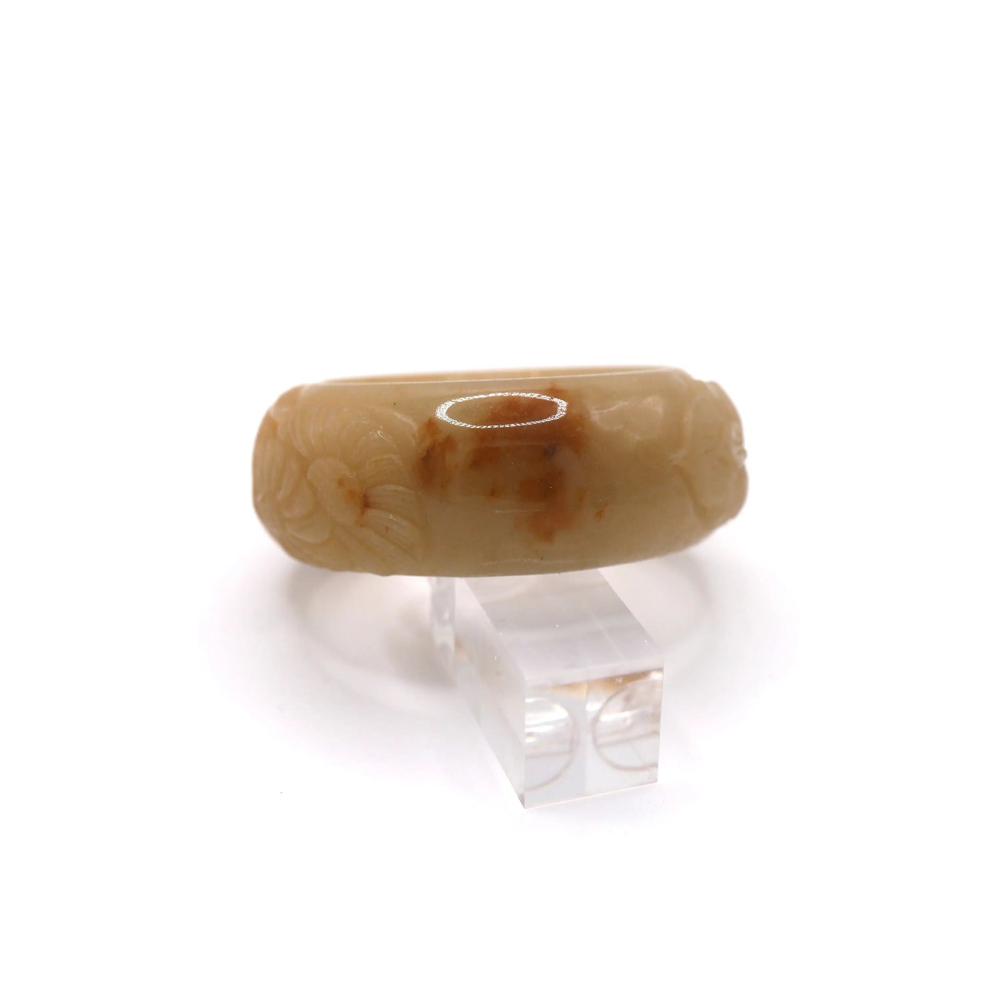 Traditional botanical symbols carved in relief onto a smooth yellow jade bracelet, blending craftsmanship and natural artistry – Miruzi