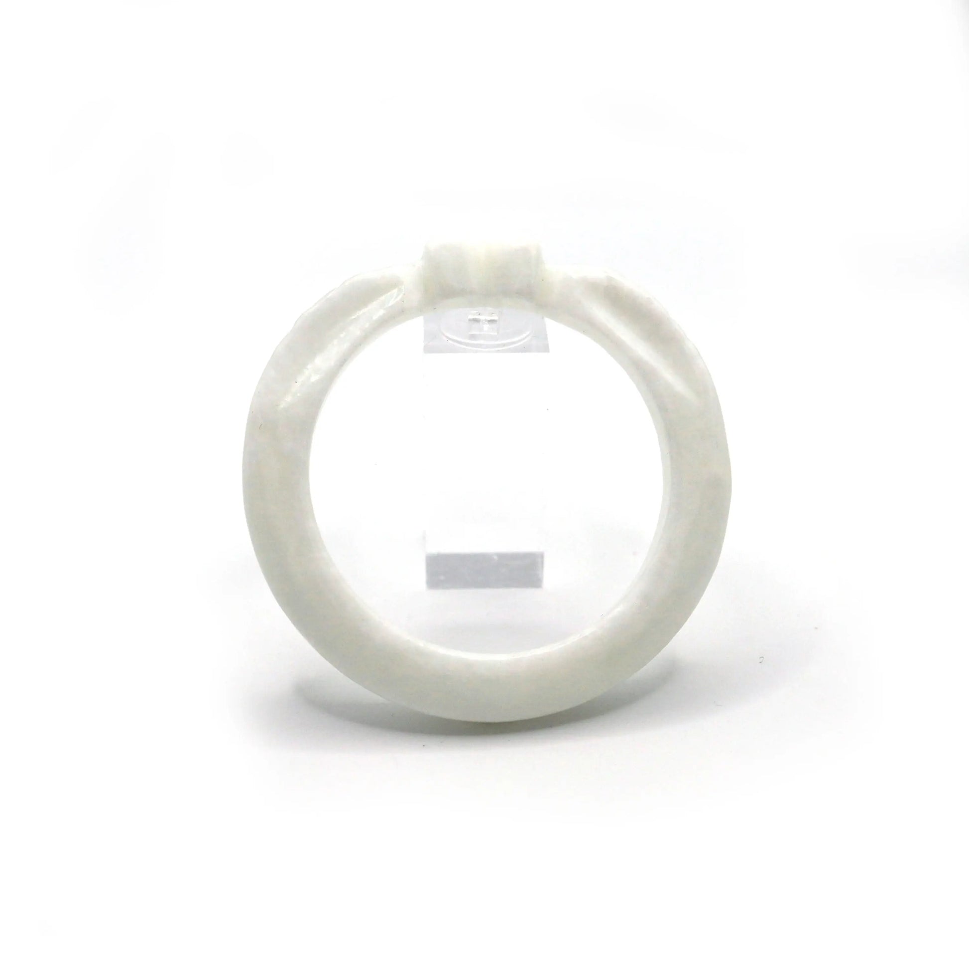 Thin white jade bracelet carved with a heart and wing-like feather designs, evoking purity and emotional symbolism – Miruzi