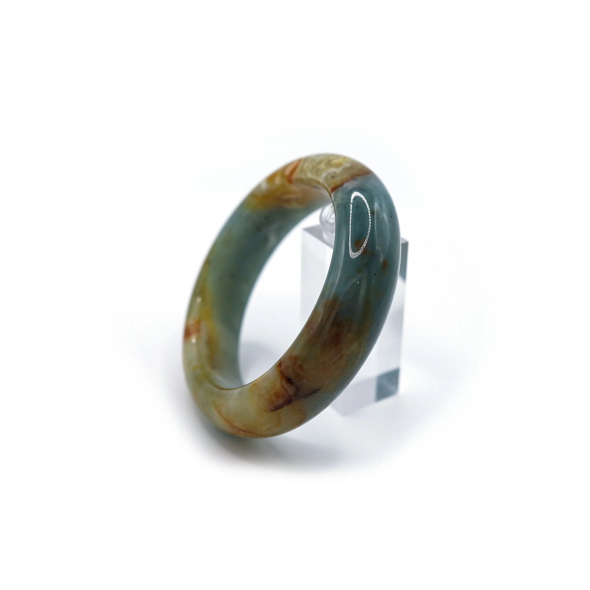 A rich blue jade bangle with unique yellow and ivory veins, capturing the spirit of ocean serenity and natural movement – Miruzi