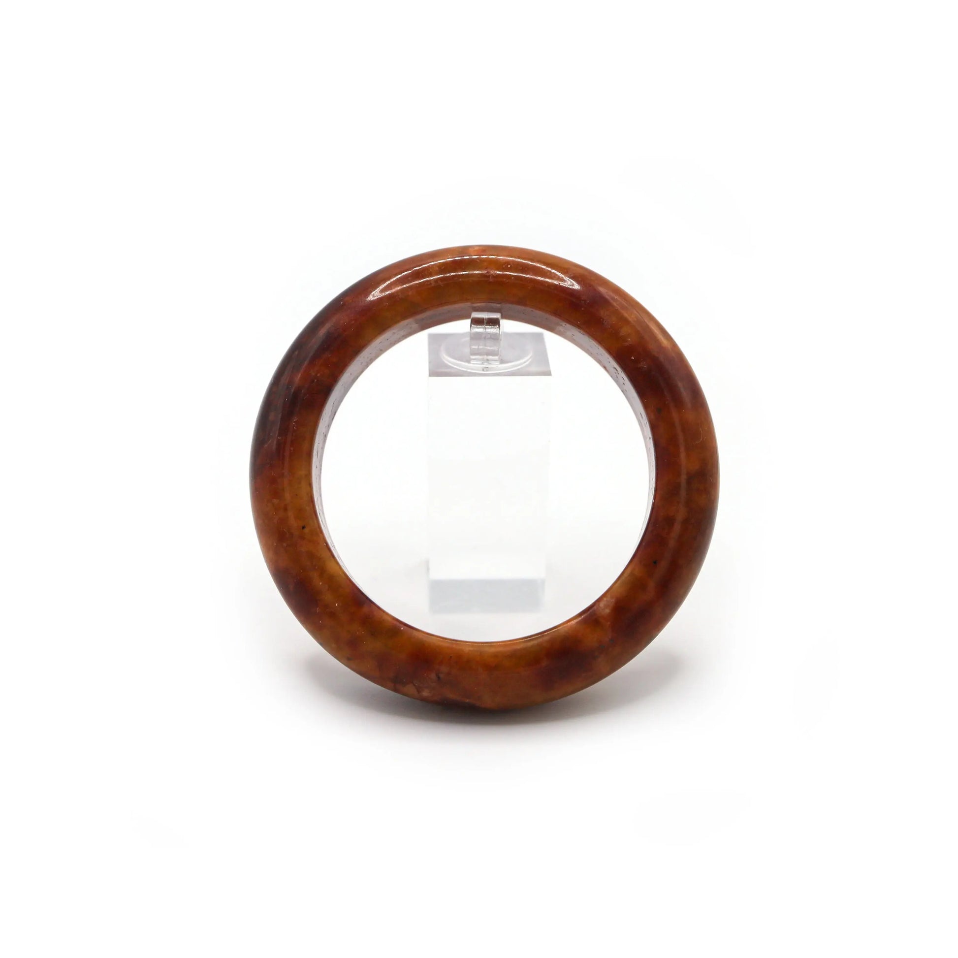 Red jade bracelet beside dried petals and soft fabric for natural styling Miruzi