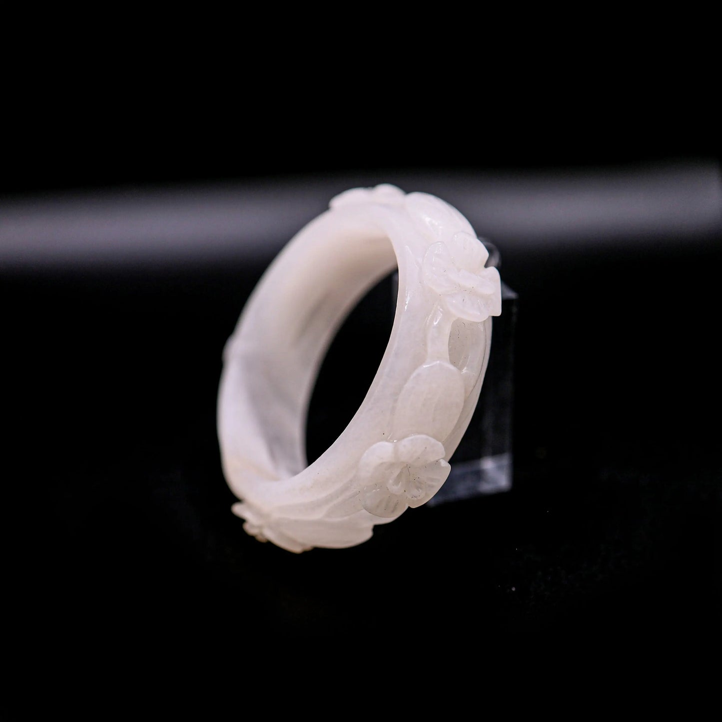 Hand-carved white jade bangle with five airy violet blossoms in various blooming stages, showcasing sculptural softness and purity – Miruzi