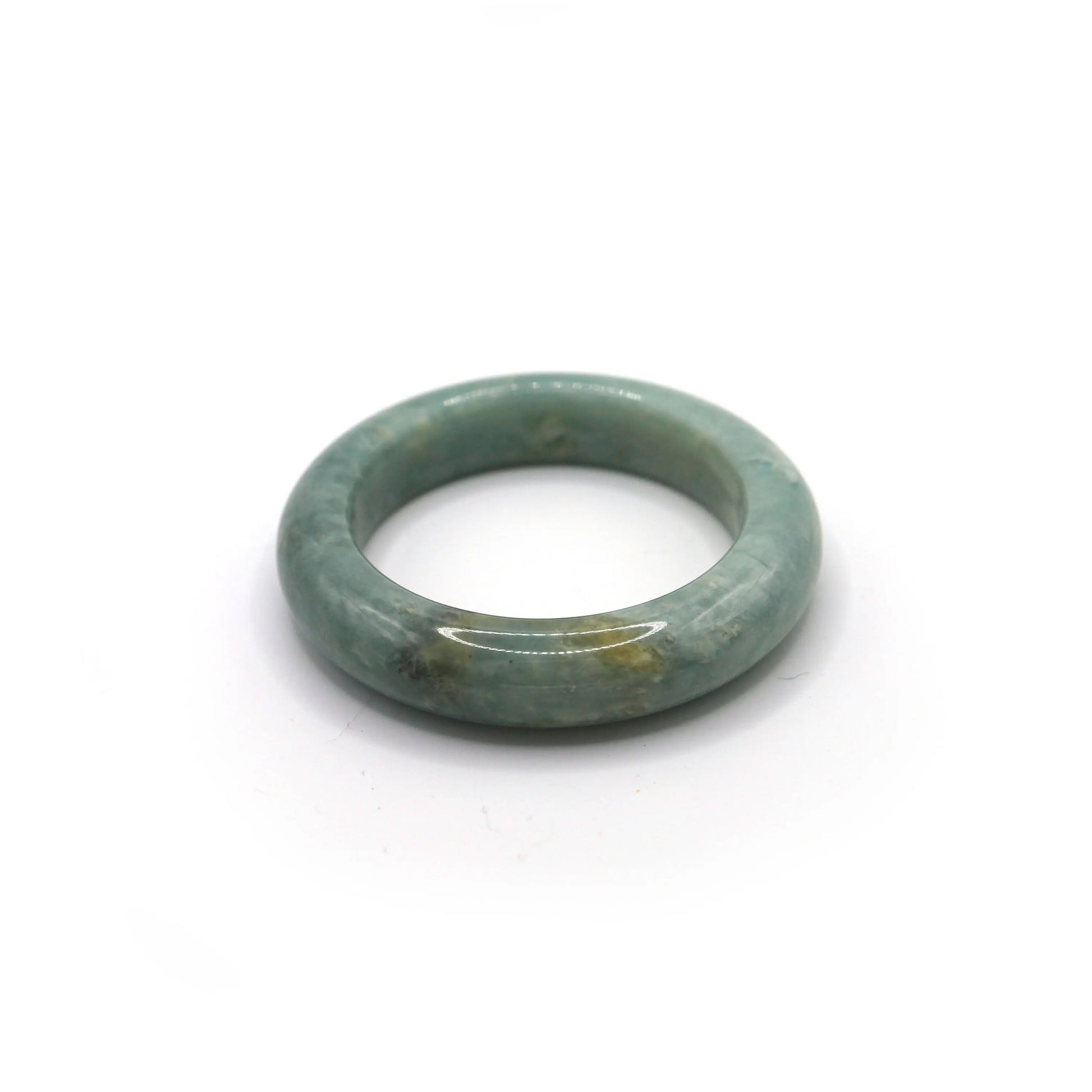 Light blue jade bangle glowing softly under natural daylight Miruzi