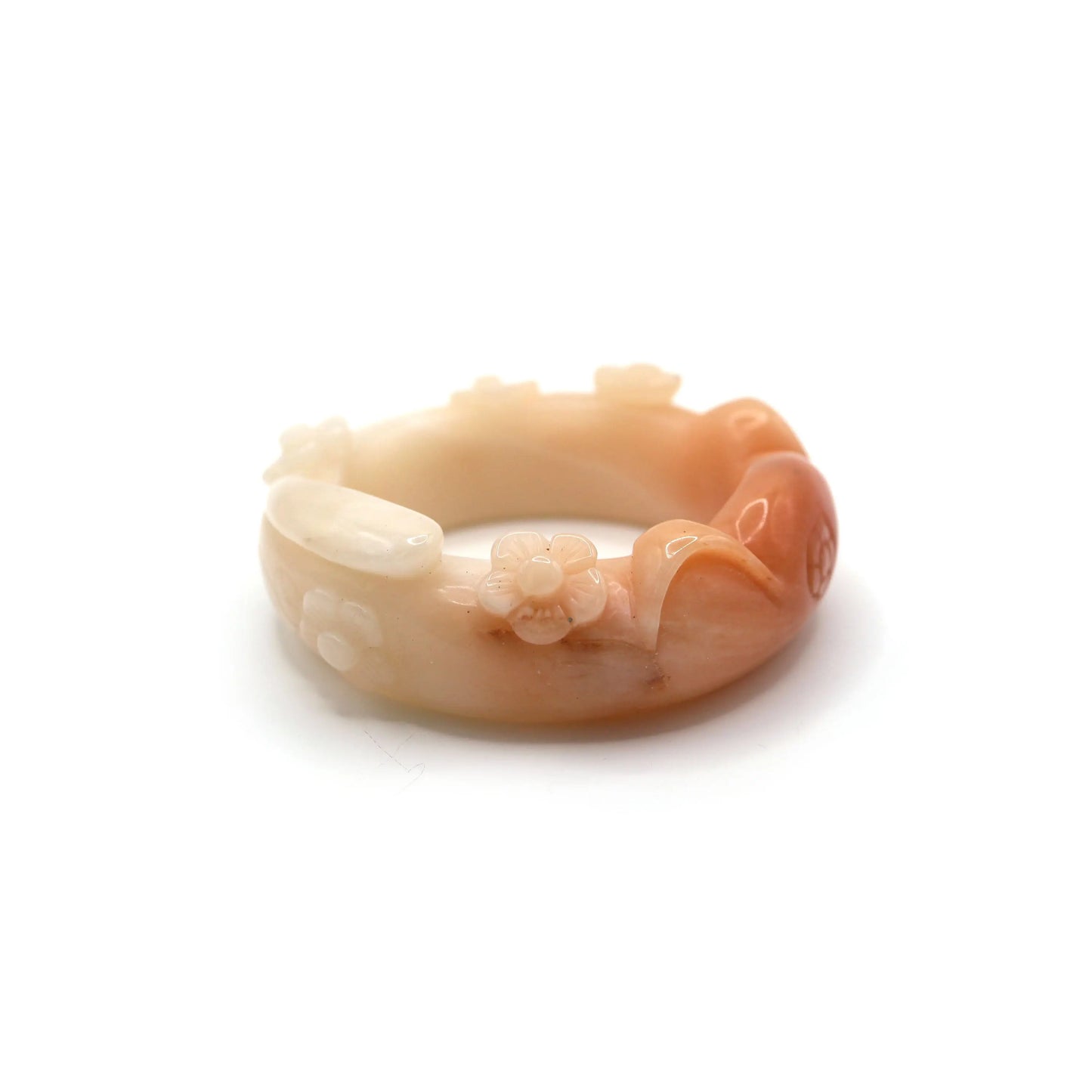 Smooth pink-orange jade bangle with feline ears and flower carvings, featuring a small, natural surface imperfection from hand-carving – Miruzi