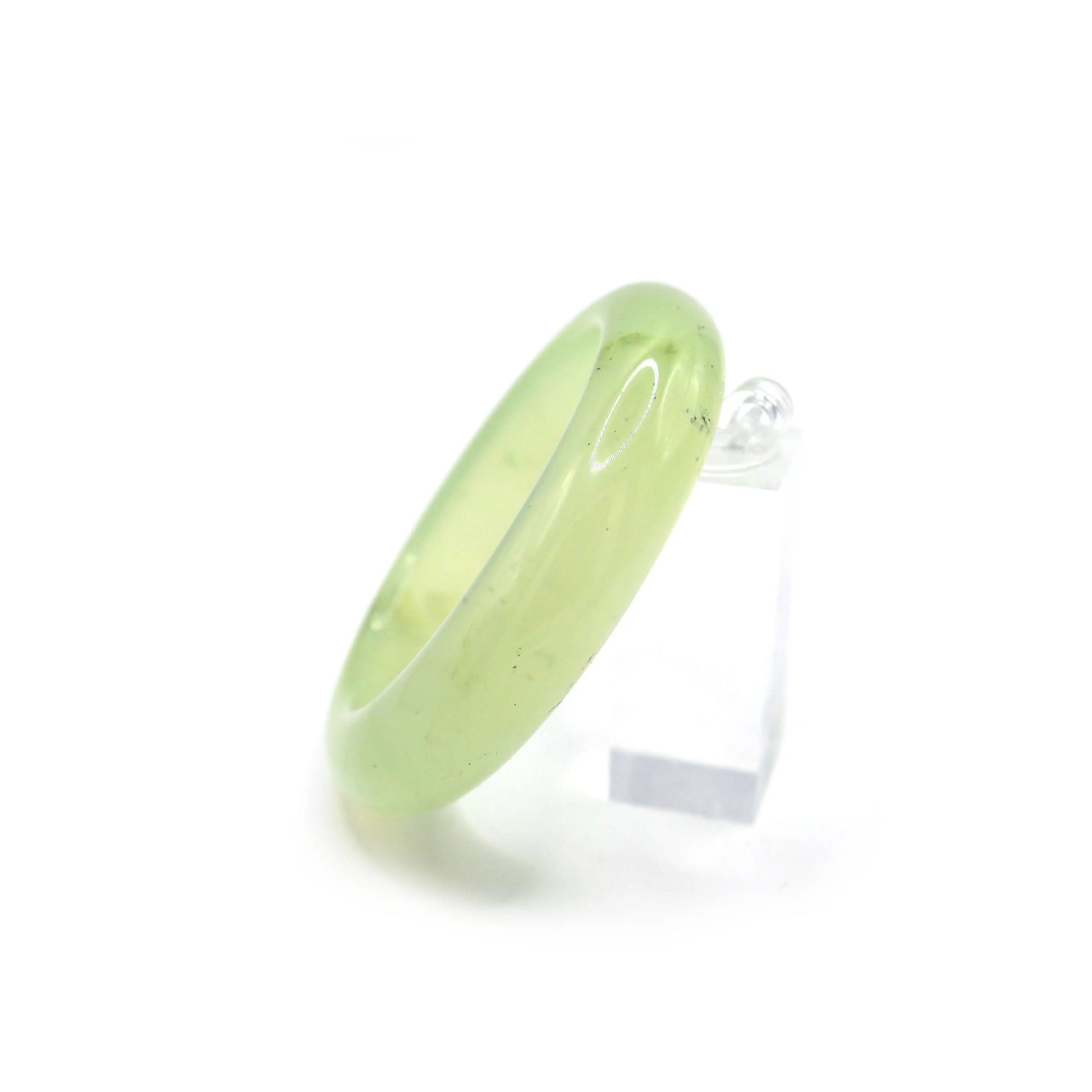 A pristine green jade bangle paired with pastel fabrics, enhancing its sheer glow and floating aesthetic – Miruzi