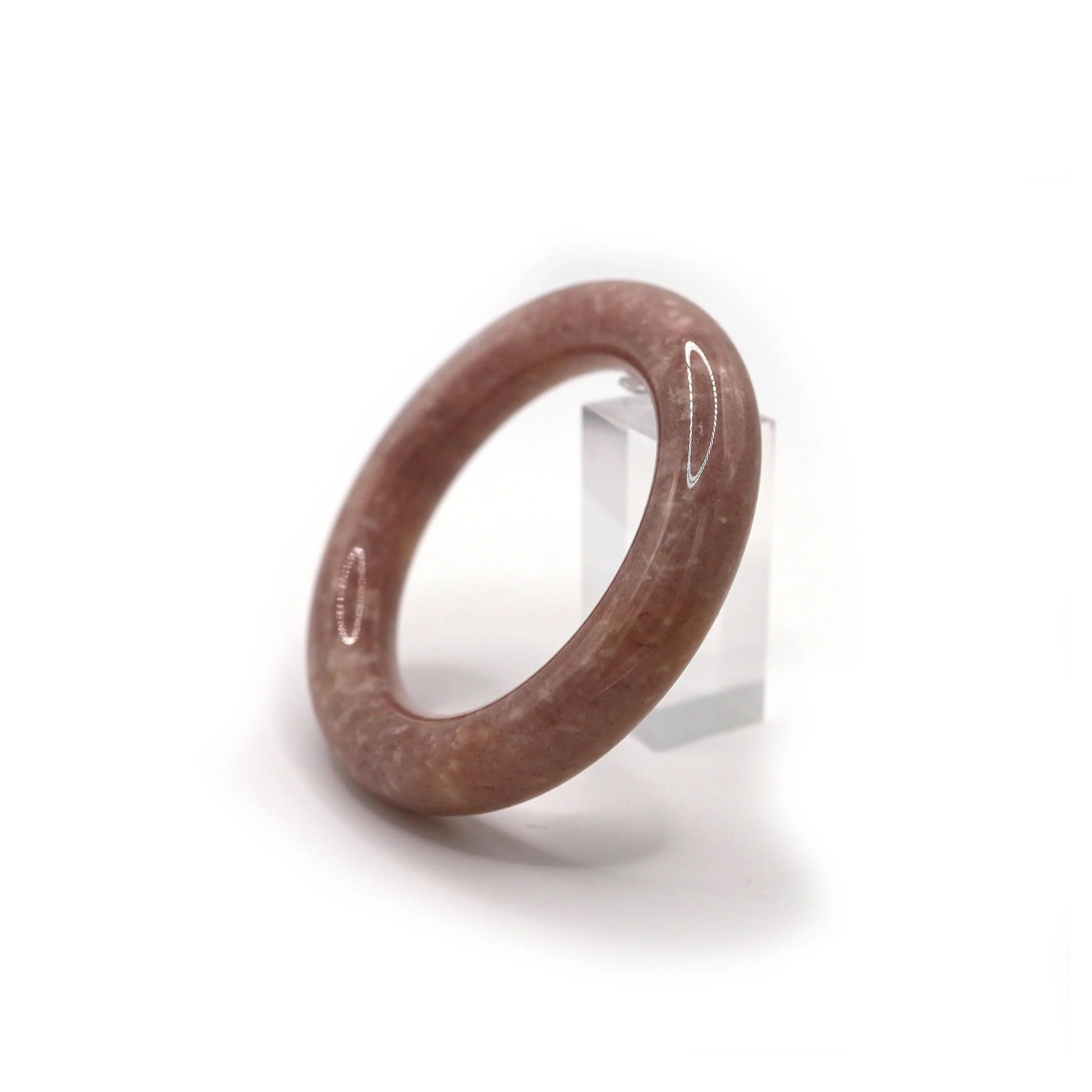 Circular jade bangle styled on cream fabric, with soft orchid tones and a dusting of white mineral inclusions for a whimsical feel – Miruzi