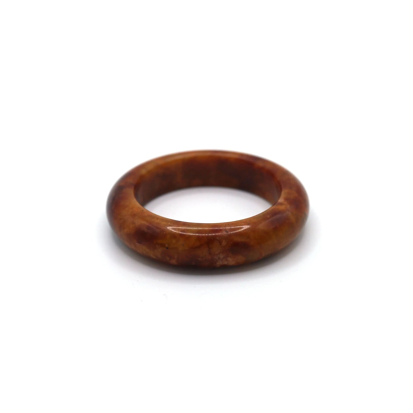 Deep red jade bracelet with soft golden and ivory veining placed on neutral background Miruzi