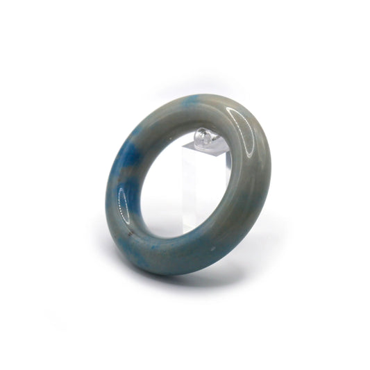Cream-colored jade bracelet styled on soft cotton, showing cloud-like blue inclusions reminiscent of airy summer skies – Miruzi