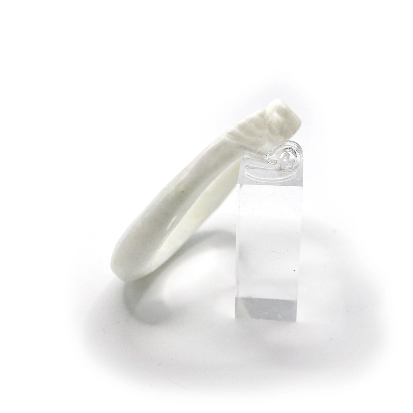Polished Mongolian jade bangle with smooth curves and symbolic motifs carved in delicate relief along the slim profile – Miruzi