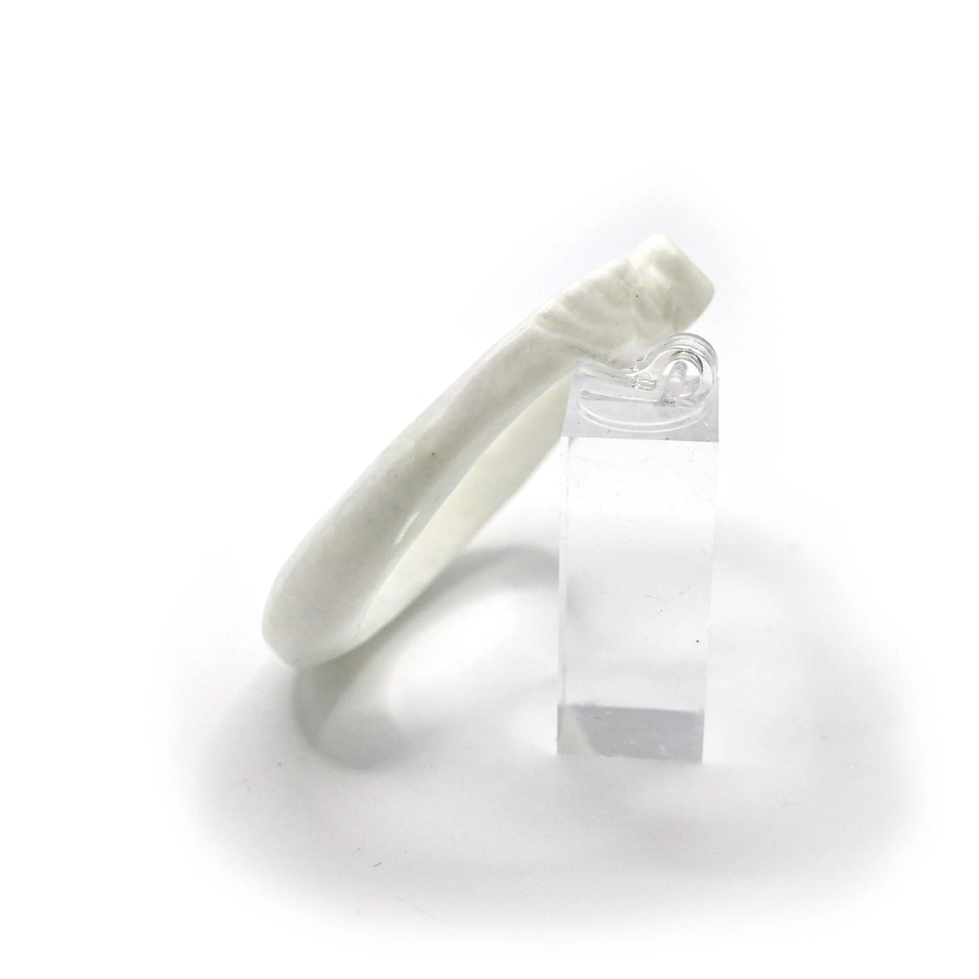 Polished Mongolian jade bangle with smooth curves and symbolic motifs carved in delicate relief along the slim profile – Miruzi