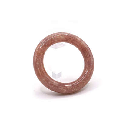 Close-up of pinkish-purple jade bangle with natural white mineral flecks resembling constellations on a twilight-colored stone – Miruzi