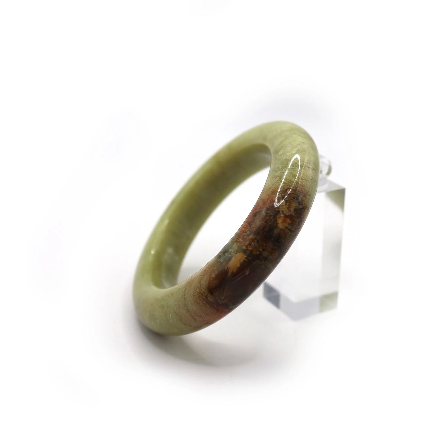 Close-up of jade bracelet showing red-brown mineral vein in soft green stone Miruzi