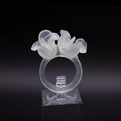 Sublime Ice Magnolia Serpentine Ring featuring crystal-clear serpentine intricately carved into three-dimensional magnolia blossoms, symbolizing purity and natural beauty. The icy, translucent base enhances the floral details, making it a perfect blend of artistry and elegance.