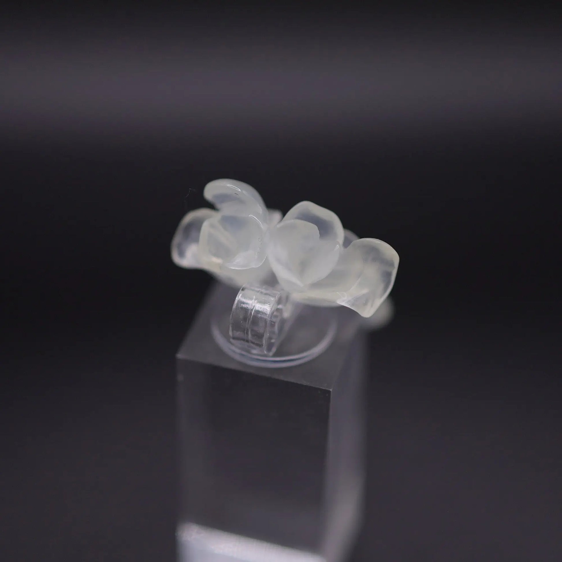 Sublime Ice Magnolia Serpentine Ring featuring crystal-clear serpentine intricately carved into three-dimensional magnolia blossoms, symbolizing purity and natural beauty. The icy, translucent base enhances the floral details, making it a perfect blend of artistry and elegance.