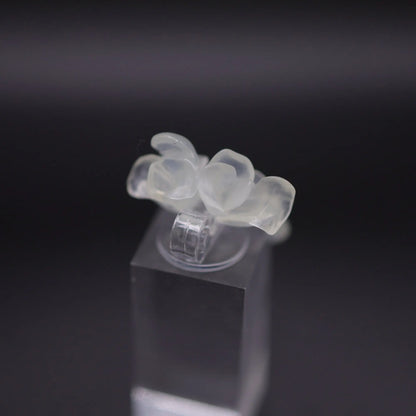 Sublime Ice Magnolia Serpentine Ring featuring crystal-clear serpentine intricately carved into three-dimensional magnolia blossoms, symbolizing purity and natural beauty. The icy, translucent base enhances the floral details, making it a perfect blend of artistry and elegance.