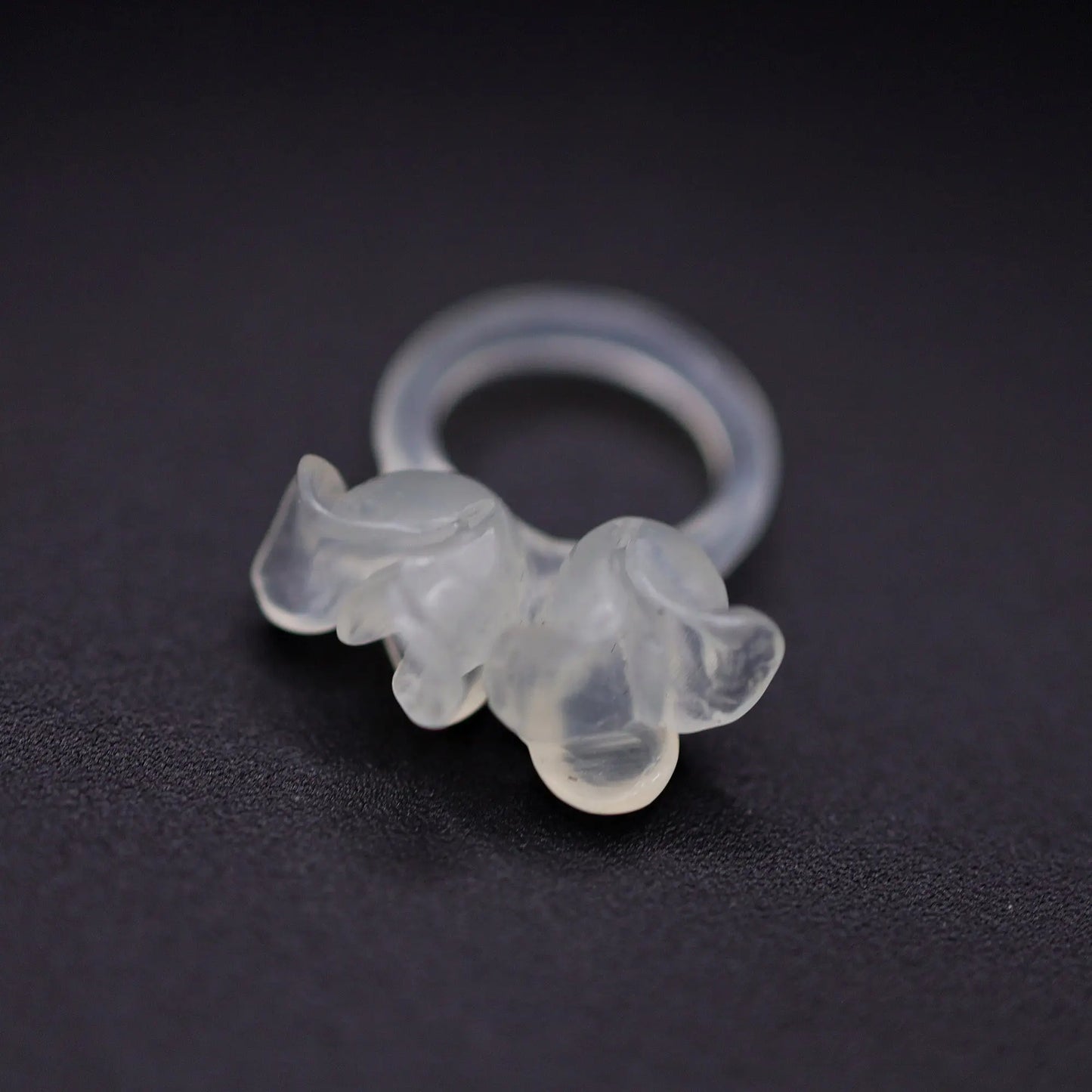 Sublime Ice Magnolia Serpentine Ring featuring crystal-clear serpentine intricately carved into three-dimensional magnolia blossoms, symbolizing purity and natural beauty. The icy, translucent base enhances the floral details, making it a perfect blend of artistry and elegance.