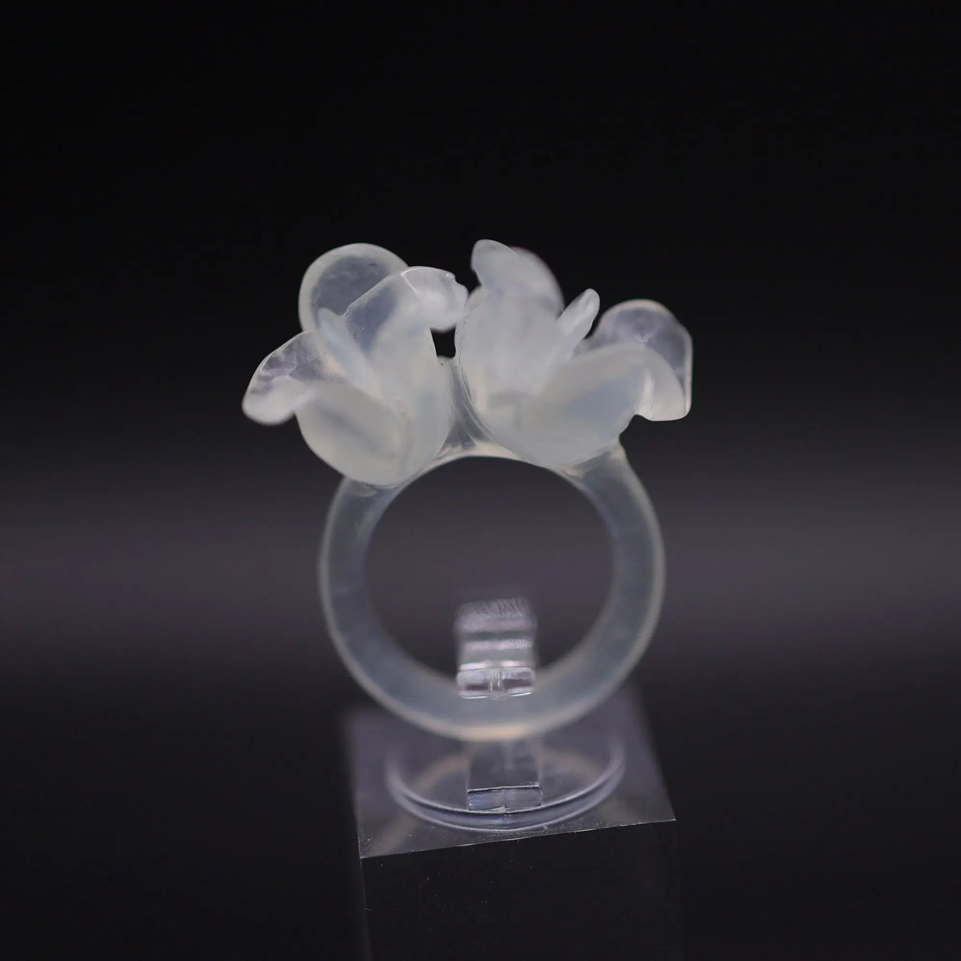 Sublime Ice Magnolia Serpentine Ring featuring crystal-clear serpentine intricately carved into three-dimensional magnolia blossoms, symbolizing purity and natural beauty. The icy, translucent base enhances the floral details, making it a perfect blend of artistry and elegance.