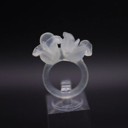 Sublime Ice Magnolia Serpentine Ring featuring crystal-clear serpentine intricately carved into three-dimensional magnolia blossoms, symbolizing purity and natural beauty. The icy, translucent base enhances the floral details, making it a perfect blend of artistry and elegance.