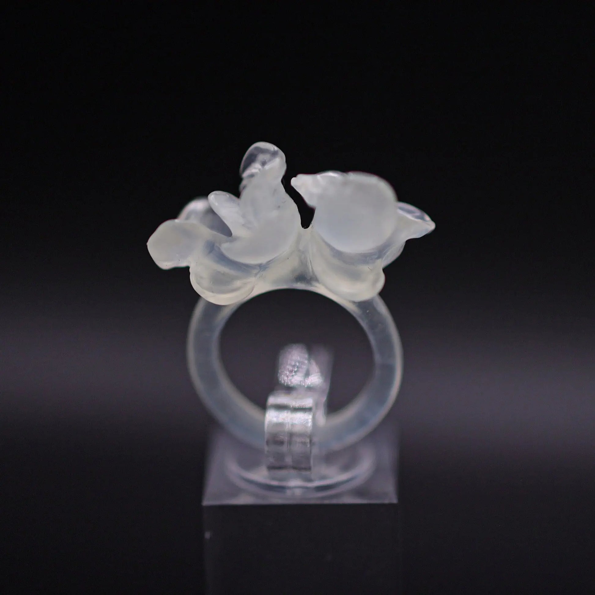 Sublime Ice Magnolia Serpentine Ring featuring crystal-clear serpentine intricately carved into three-dimensional magnolia blossoms, symbolizing purity and natural beauty. The icy, translucent base enhances the floral details, making it a perfect blend of artistry and elegance.