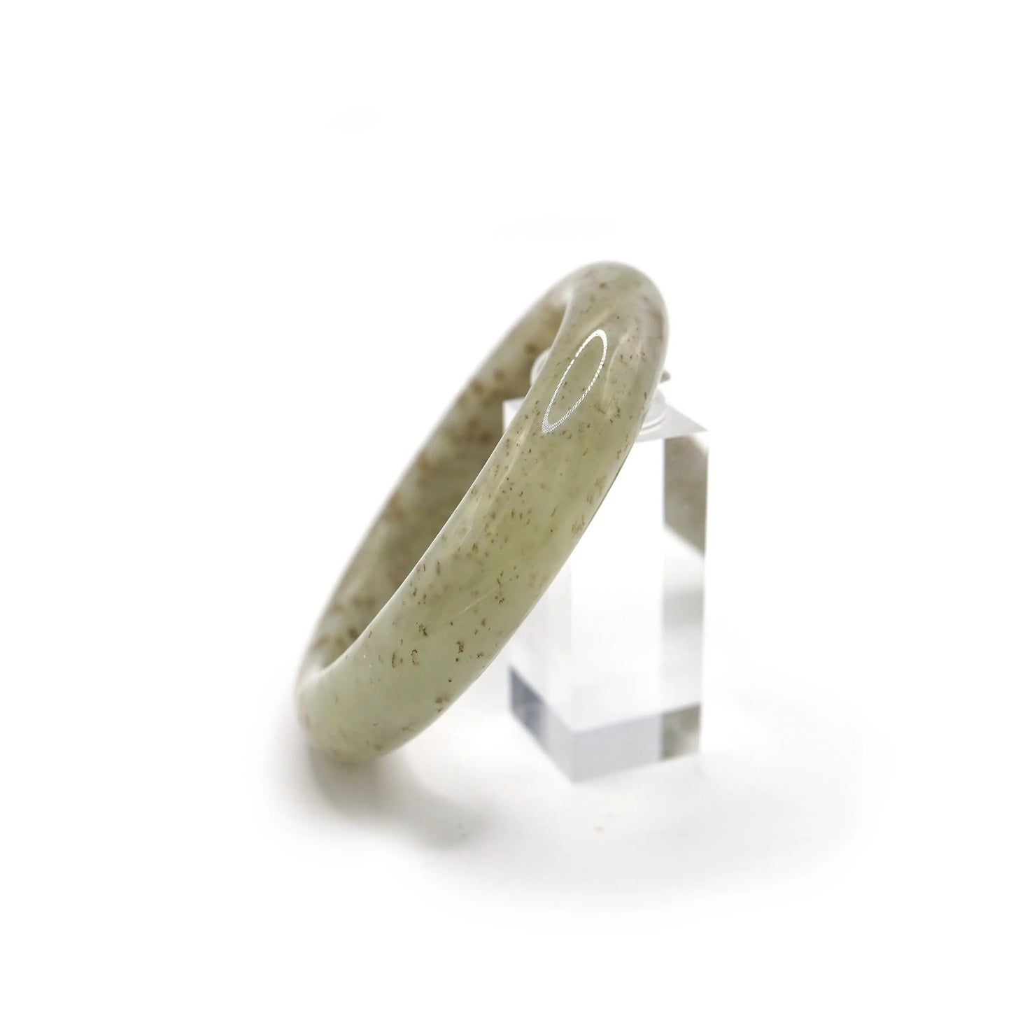 Elegant jade bracelet on neutral backdrop, featuring a clean beige hue with scattered botanical-like mineral flecks – Miruzi