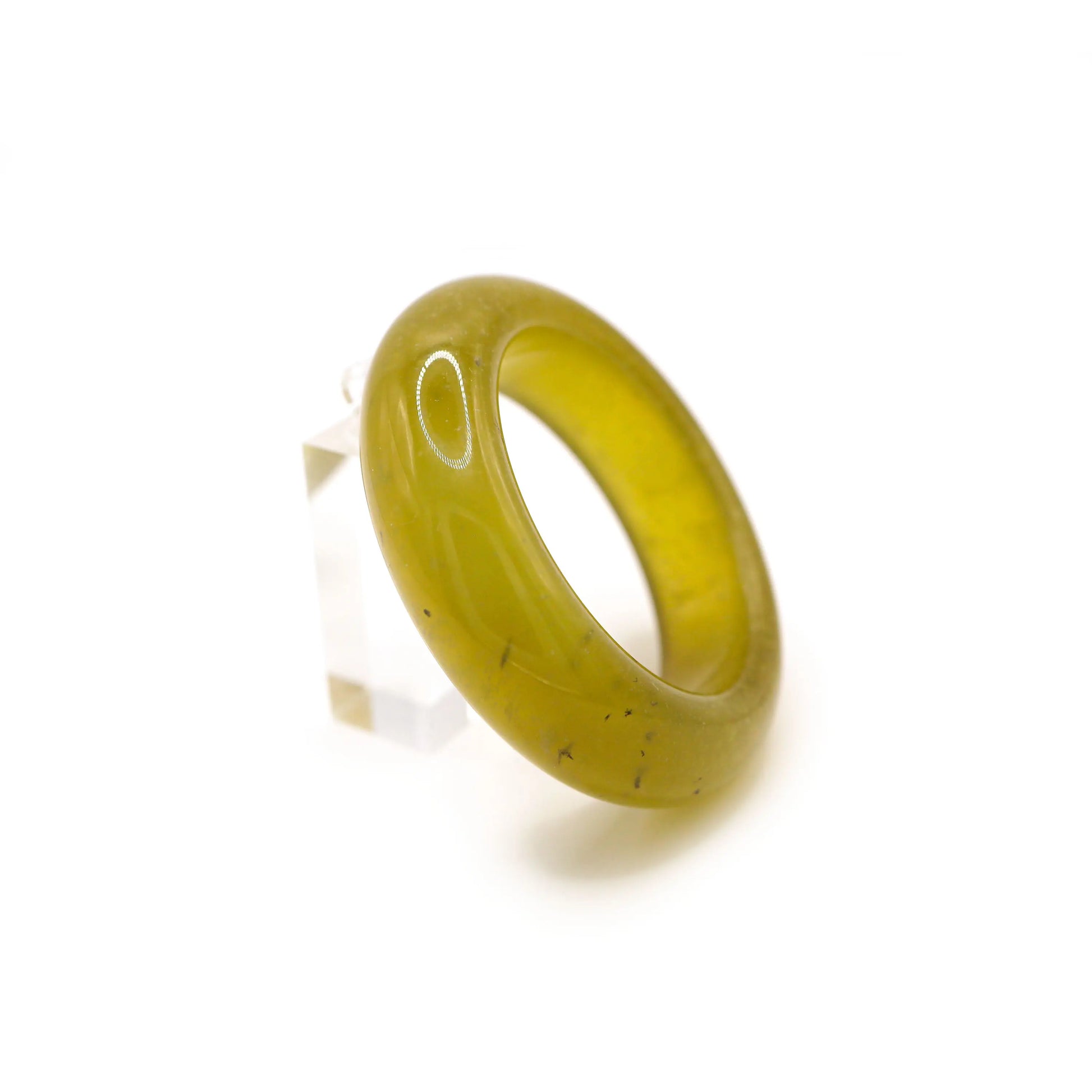 Full view of a circular transparent jade bangle with beer-gold color and bubbly inclusions, ideal for warm weather styling. Miruzi