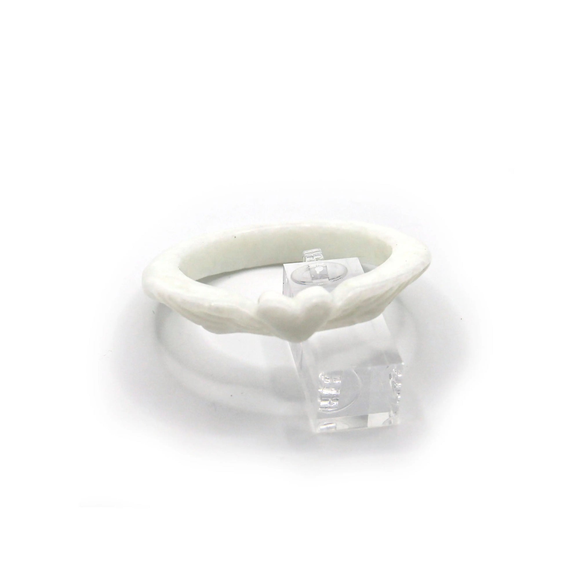Slim Mongolian white jade bracelet with delicately carved heart at the center and feather designs on each side, glowing with soft translucence – Miruzi