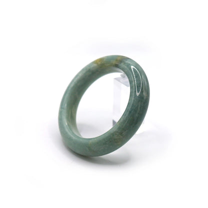 Woman wearing pale blue jade bracelet with soft-toned casual outfit Miruzi