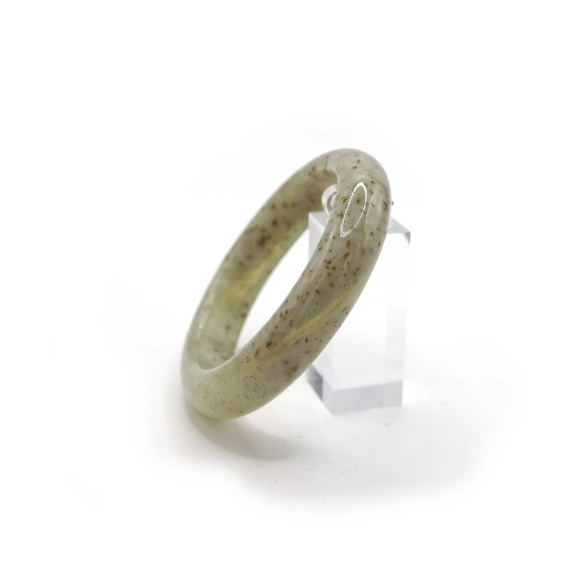 Jade bangle carved from pale beige stone, with organic brown spots scattered like seeds across a misty, glowing surface – Miruzi