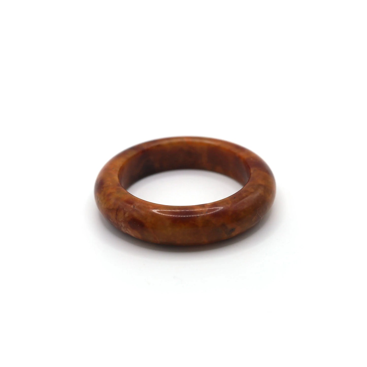 Red jade bracelet styled with muted cream and walnut-toned silk fabric Miruzi