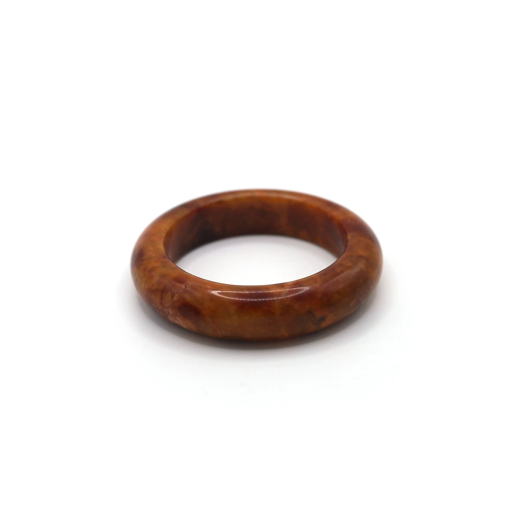 Red jade bracelet styled with muted cream and walnut-toned silk fabric Miruzi