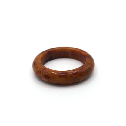 Red jade bracelet styled with muted cream and walnut-toned silk fabric Miruzi