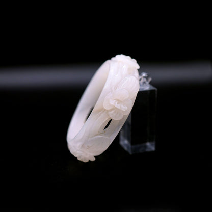 Jade bangle with detailed hand-carved flowers in an airy openwork style, forming a quiet and graceful rhythm around the wrist – Miruzi