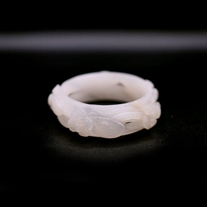 Elegant white quartzite jade bracelet featuring cutout floral motifs, each petal gracefully curling outward in hand-carved relief – Miruzi