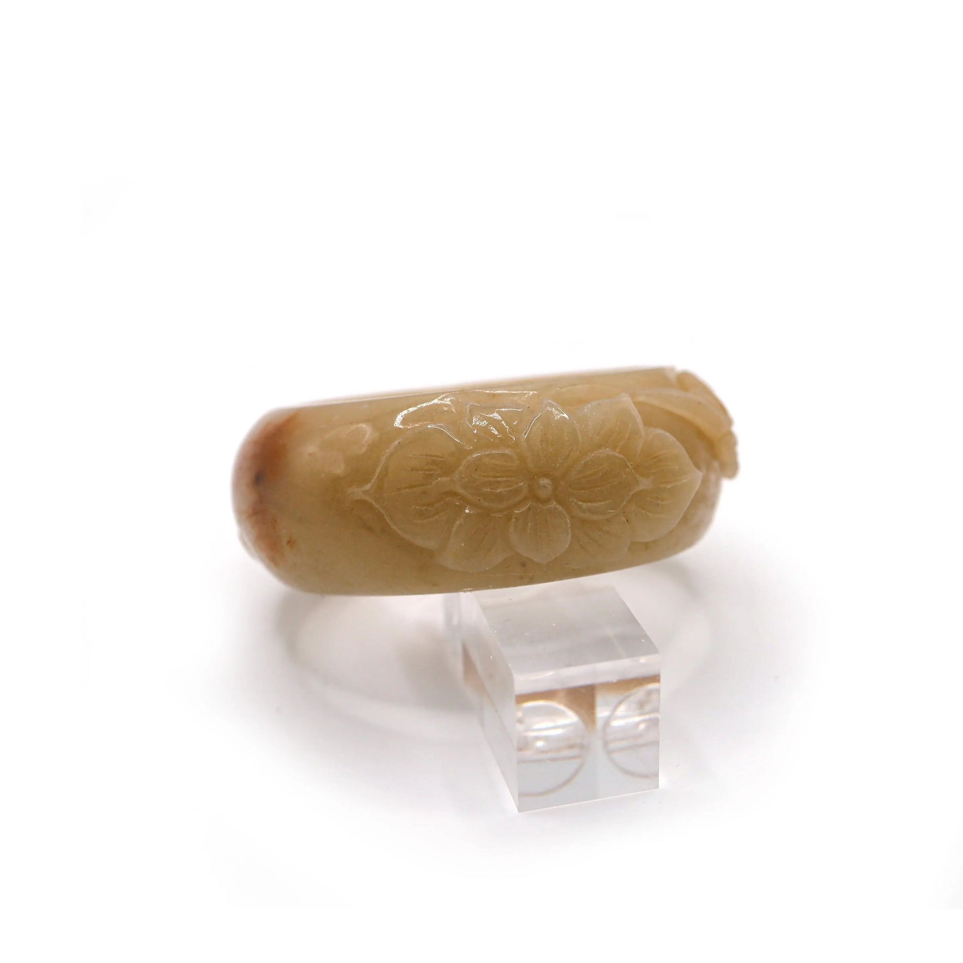 Detailed botanical carving of the Four Gentlemen on a warm yellow jade bangle with visible orange mineral patch near the edge – Miruzi