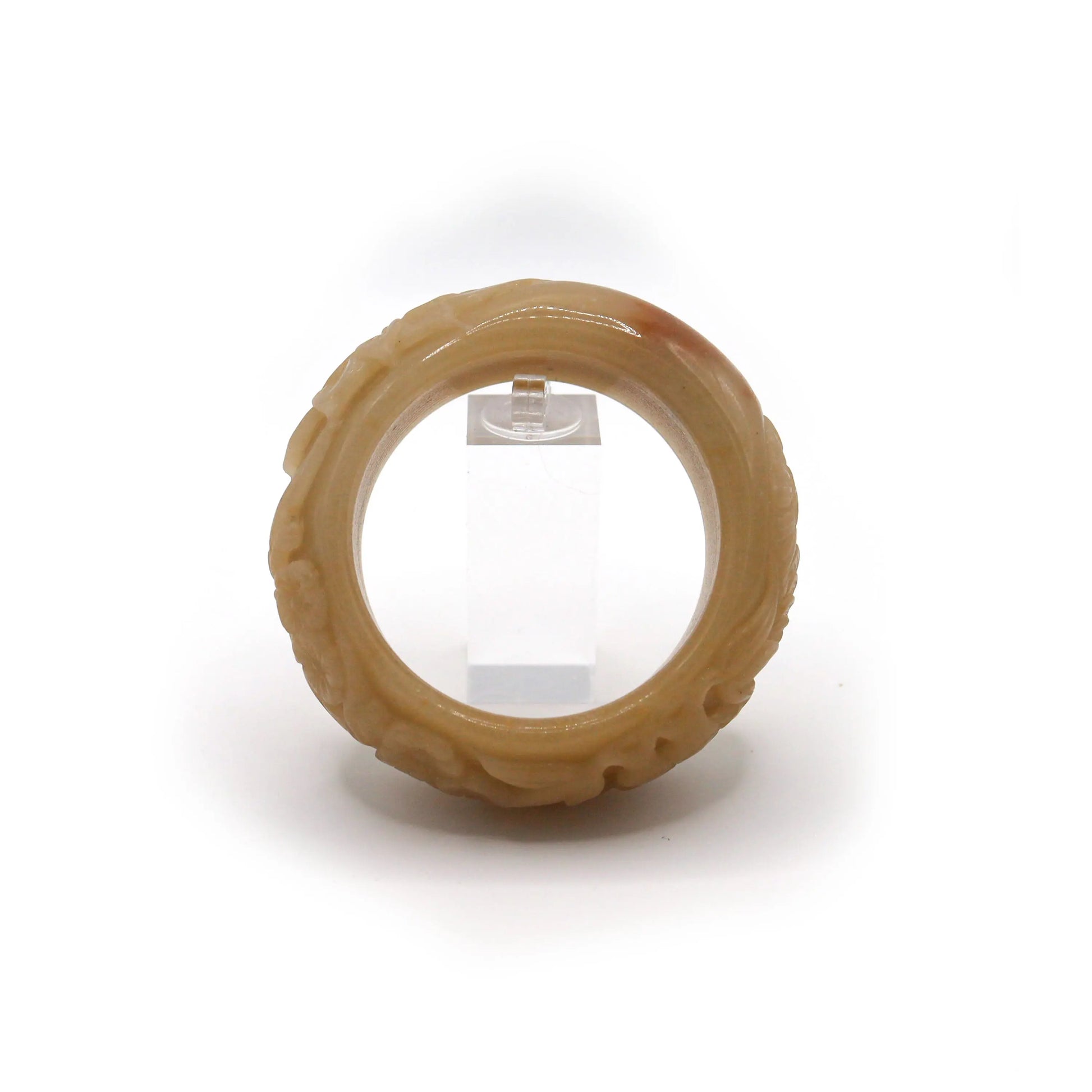 Warm-toned jade bracelet with visible orange mineral inclusion and carved depictions of the Four Gentlemen across its band – Miruzi