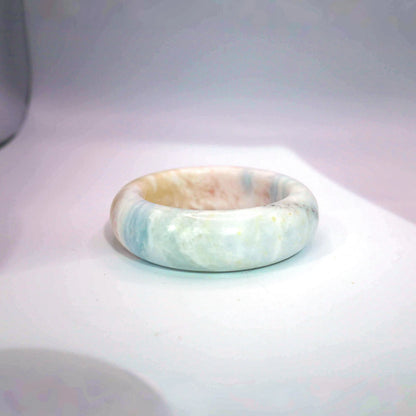 Light blue jade bangle with dreamy pastel tones of blue, pink, and white in an ice-translucent natural finish

