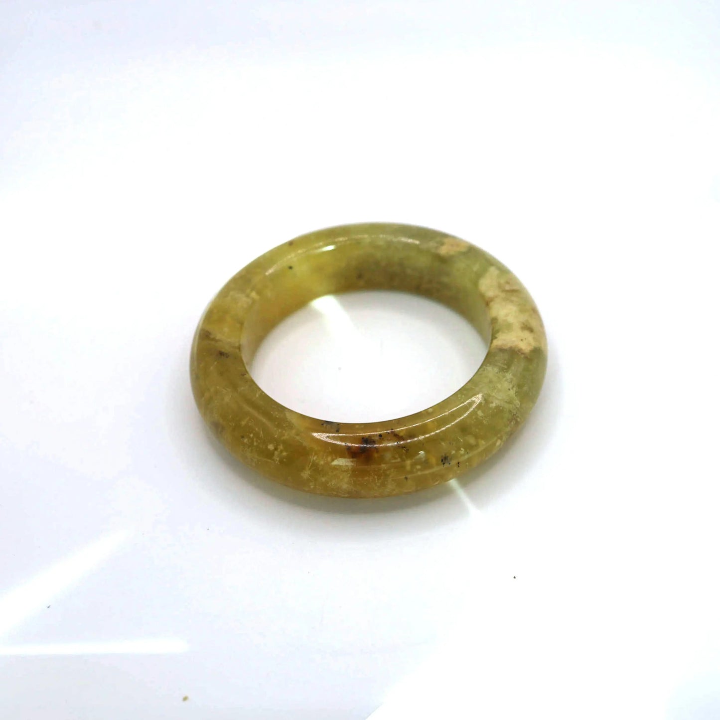 Semi-transparent jade bangle with botanical mineral flow, carved in traditional zhengquan circle

