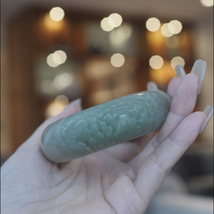 Soft green Mongolian jade bracelet featuring a single sculpted peony blossom on one side, blending minimalist form with floral artistry in natural quartzite – Miruzi